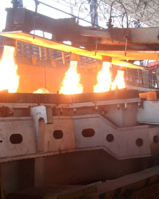 Industrial gas burners firing in synchronized operation on a furnace platform in a steel manufacturing unit